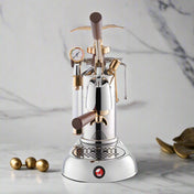 La Pavoni Expo 2015 Coffee Machine featuring a sleek chrome and gold design with lever mechanism, pressure gauge, and drip tray, showcasing elegant Italian craftsmanship in chrome-plated steel with bronze accents on a marble countertop